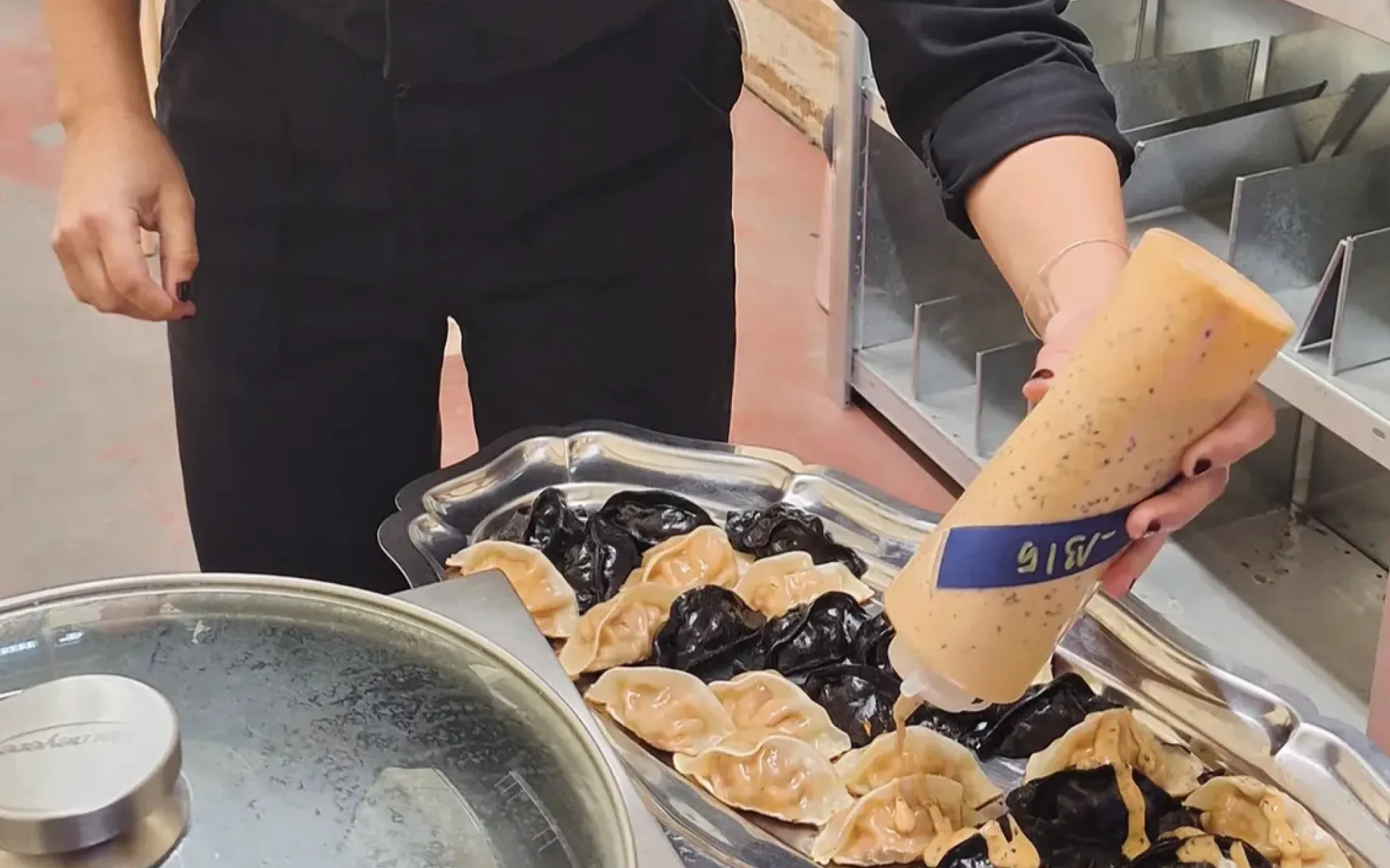 Signature black and classic gyozas finished with MAFFOOD sauce before being served at the Gallery Collective opening.